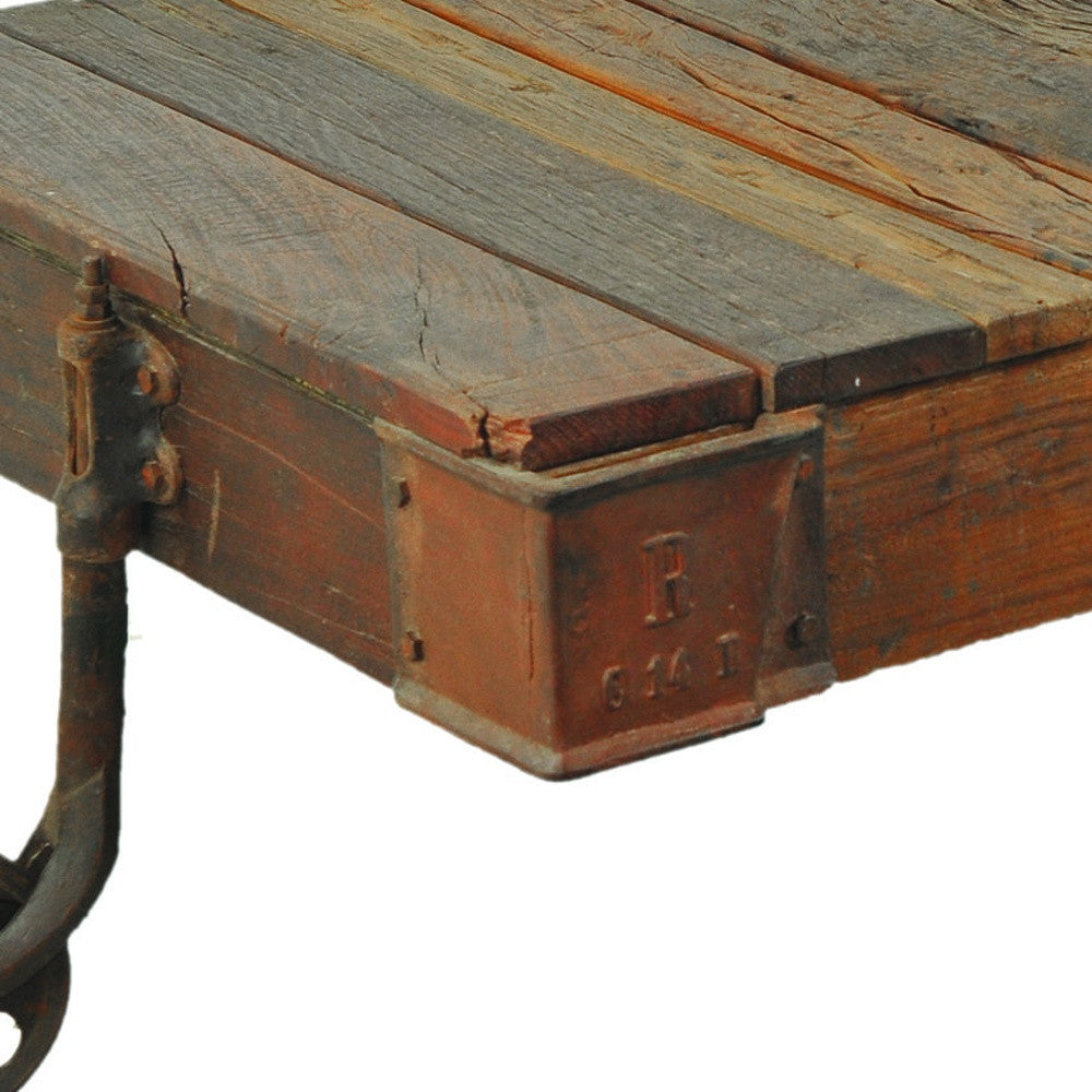 50" Brown and Black Solid Wood and Iron Distressed Wheel Coffee Table