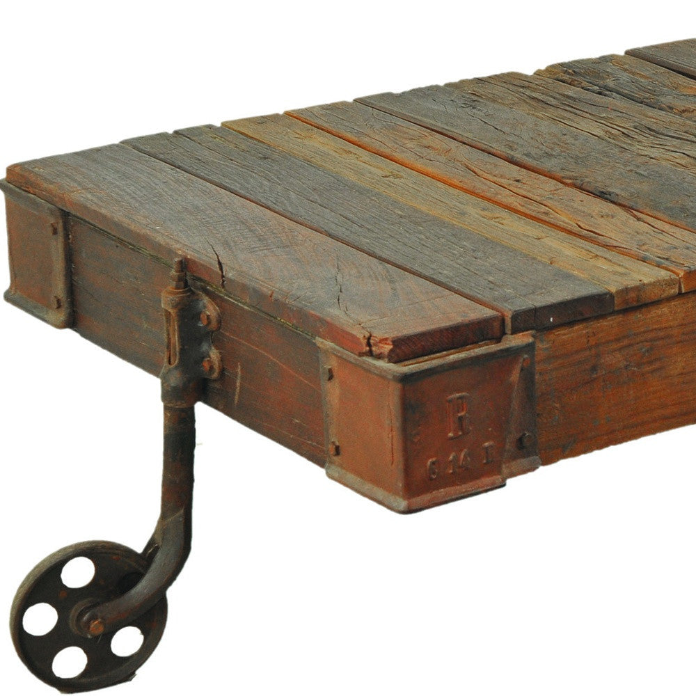 50" Brown and Black Solid Wood and Iron Distressed Wheel Coffee Table
