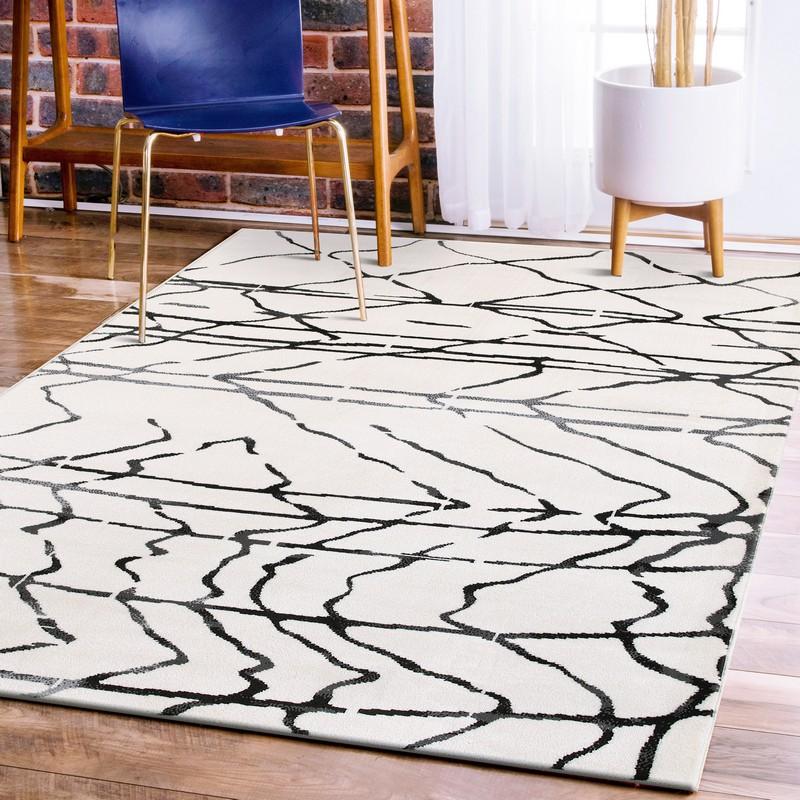 5’ x 7’ Cream and Black Distored Berber Area Rug