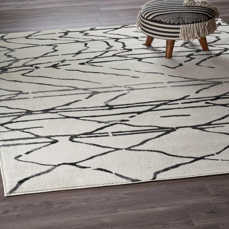 5’ x 7’ Cream and Black Distored Berber Area Rug